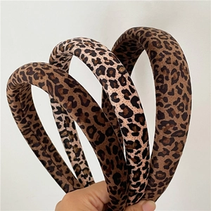 Detailed view of assorted leopard print fabric headbands with thick sponge padding