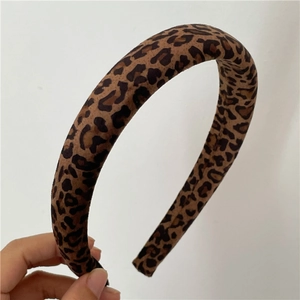 Detailed view of the soft leopard print fabric texture on a thick padded retro headband