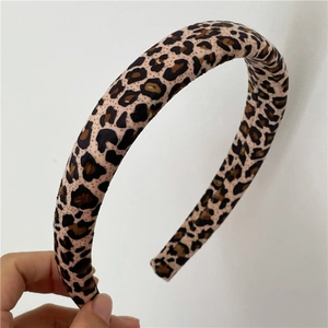 Close-up detail of thickened sponge leopard print headband with retro brown fabric texture