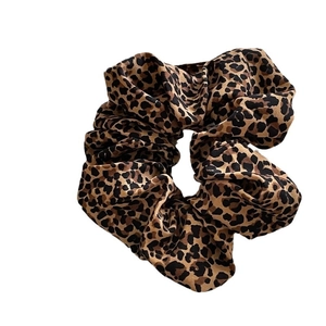 Classic leopard print scrunchie with elastic hair tie design on plain white background