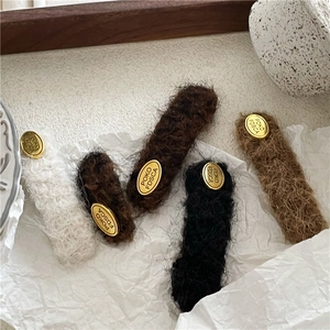 Plush fabric geometric hair clips with gold metal detail in four assorted colors