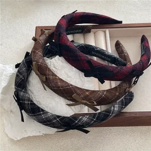 Three-piece set of thick checkered headbands with small bow accents and handmade label
