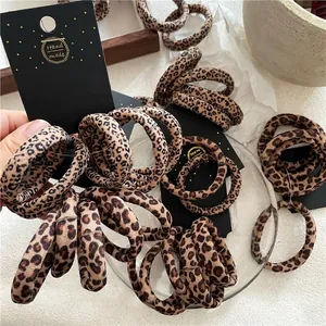 Five-piece set of leopard print hair scrunchies on a handmade display card