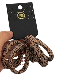 Five-pack leopard print elastic hair scrunchies set on handmade display card