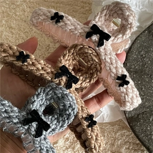 Knitted hair claw clips in pink, brown, and grey with black velvet bow decorations