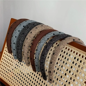 Detailed view of thick polka dot headbands in various colors on a vintage chair