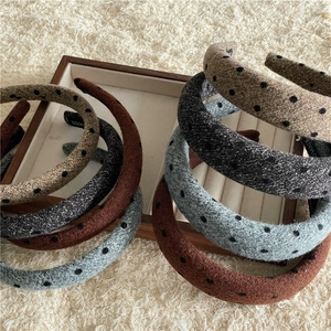 Detail view of thickened polka dot sponge headbands with handmade interior label
