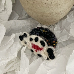 Macro detail of handmade wool felt candy hair tie with colorful knit textures