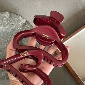 Detailed macro view of burgundy matte hair claw clips with Barrette La France gold lettering