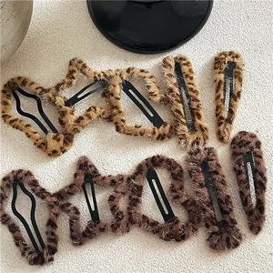 Detail of plush leopard print hair clips in various star and teardrop geometric shapes