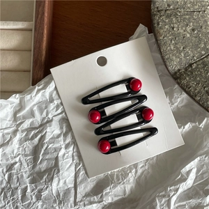 Set of four black metal teardrop hair clips with glossy red round bead decorations