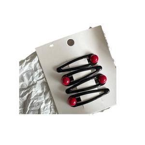Set of 4 black water drop BB hair clips with vibrant red bead accents on a display card