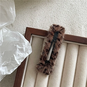 Close-up of brown leopard print plush rectangle hair clip with soft faux fur texture