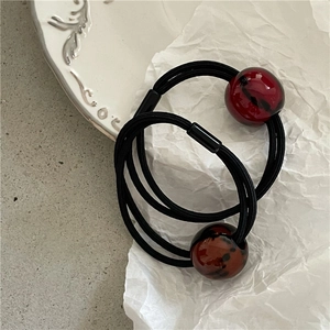 Dual leopard pattern beaded elastic hair bands with marble texture on grey background