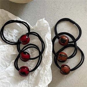 Close-up of leopard print marble beads on elastic hair bands with black fiber detail