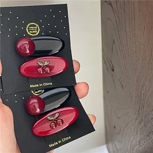 Sweet red cherry hair clips set with oval snap pins for girls on black display card