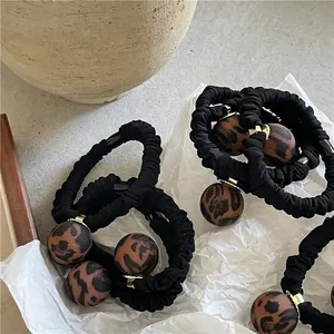 Matte leopard print beaded hair ties with black pleated elastic bands in a set