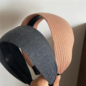 Set of two wide knitted headbands in dark grey and peach with anti-slip inner teeth