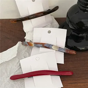 Chic acetate hair clip set in marble and tortoiseshell patterns on elegant white cards