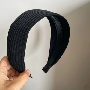Detail of black ribbed fabric headband showing interior non-slip teeth and texture