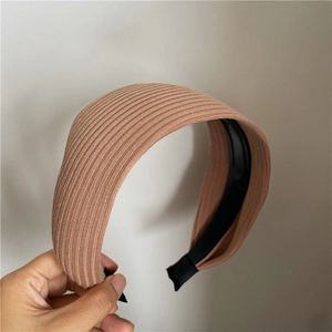 Detail of pink brown ribbed knit headband featuring non-slip teeth for secure grip