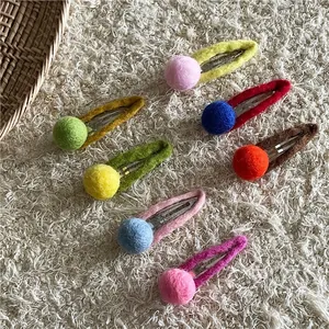 Set of colorful handmade wool felt ball hair clips for girls in various pastel color tones