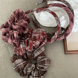 Vintage red-brown plaid fabric headbands and scrunchies set on aesthetic background