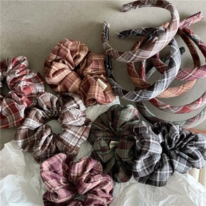 Detail of handmade plaid scrunchies and headbands featuring classic British tartan patterns