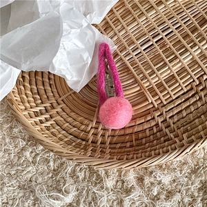 Detail view of pink wool felt BB hair clip with a soft pompom decoration for girls