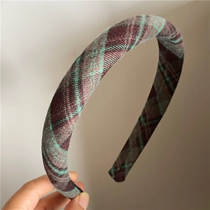 Side view showing thick padded texture of retro plaid headband in wool fabric