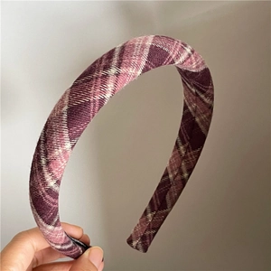 Detail of a purple and white plaid wide headband with textured woolen fabric finish