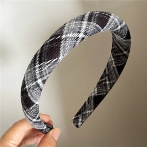 Detail showing the thick padded plaid headband with classic black and white checkered fabric