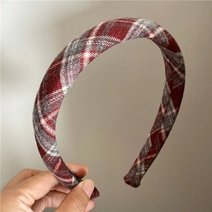 Detail of classic red and grey plaid fabric texture on a padded preppy style headband