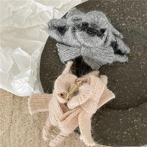 Detail showing soft knitted texture of grey and pink bow hair claw clips for women