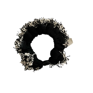 Elegant black and white contrast scrunchie with fringe tassels for stylish ponytail styles