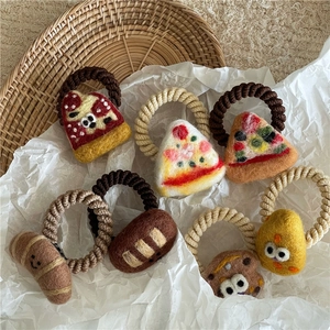 Detailed texture of handmade wool felt hair ties with cute cartoon food shapes