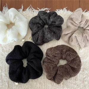 Chouchous en tricot de cinq couleurs avec petits pendentifs cœur dorés sur tapis doux