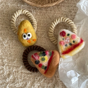 Three handmade wool felt hair ties featuring cute cartoon cheese pizza and bread designs
