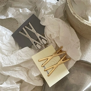 Set di 2 fermagli per capelli in metallo spazzolato a forma di X in oro opaco e argento