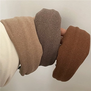 Three wide fabric headbands in coffee, taupe, and caramel colors with woolen texture