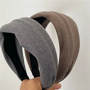 Detailed view of thick fabric headbands in grey and coffee brown for autumn and winter