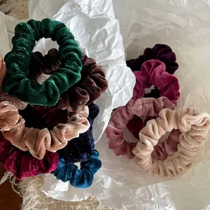 Set of ten colorful velvet scrunchies with ribbed texture for hair styling