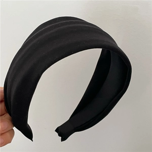 Detail of wide black padded headband with matte fabric and soft sponge filling