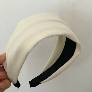 Detail view of thickened cream padded headband showing soft matte fabric and premium texture
