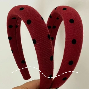 Detail shot of red knit headband set with black polka dots and thickened sponge padding