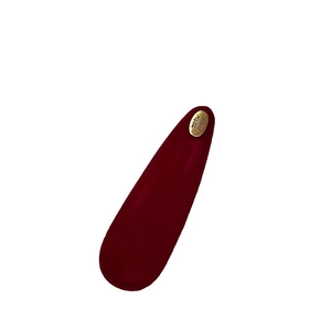 Retro burgundy suede hair clip with a gold handmade engraved metal tag on white background