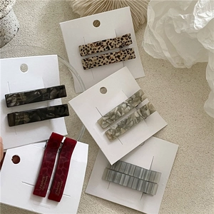 Detail of assorted tortoiseshell acetate rectangular hair clips on display card