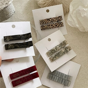 Rectangle acetate hair clips set with leopard and marble patterns on display