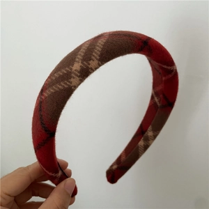 Detailed texture of red and brown thick sponge headband with vintage plaid pattern