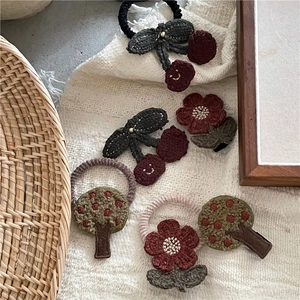 Handmade crochet floral and cherry hair clips and ties set for children in retro colors
